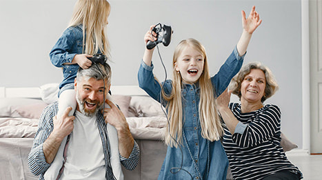 Grandparents with their granddaughters playing video games